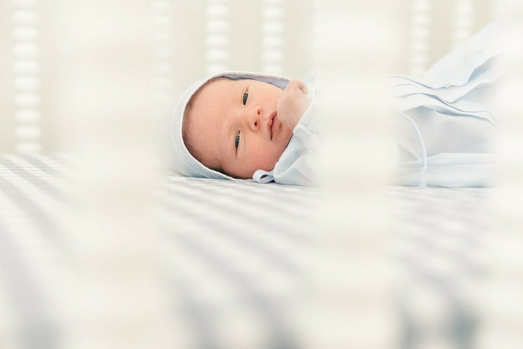 What is Lifestyle Newborn Photography? 5 newborn baby boy in a bonnet