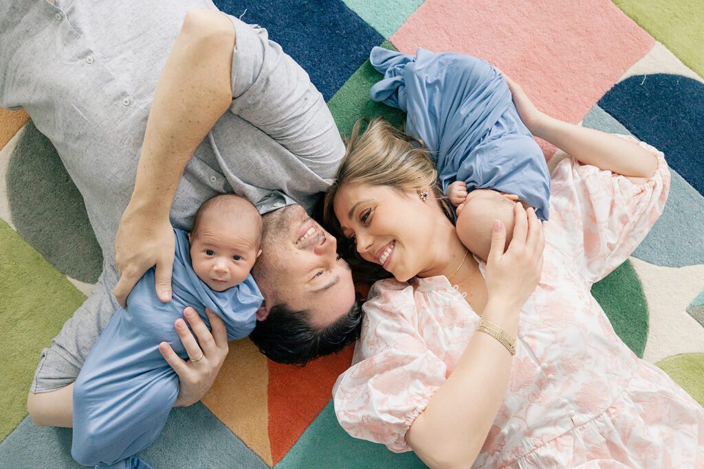 family on the floor for newborn photos with twins