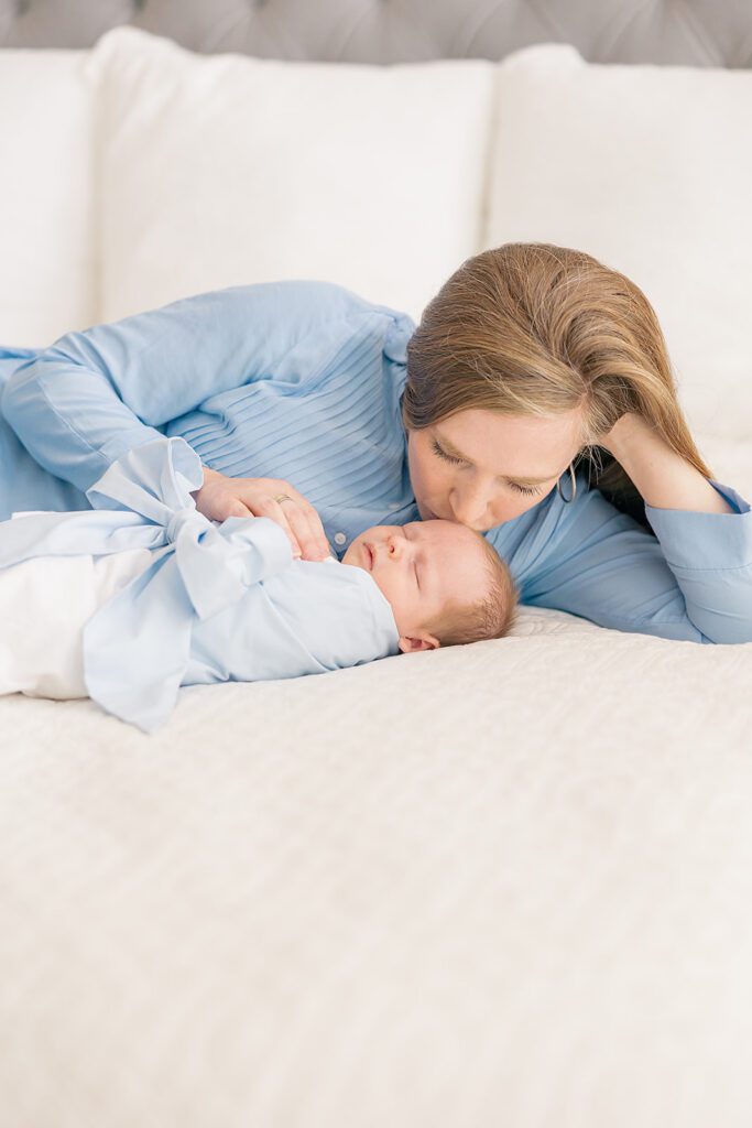 Tallahassee newborn photographer captures tender mother and baby moment during relaxed in-home session.